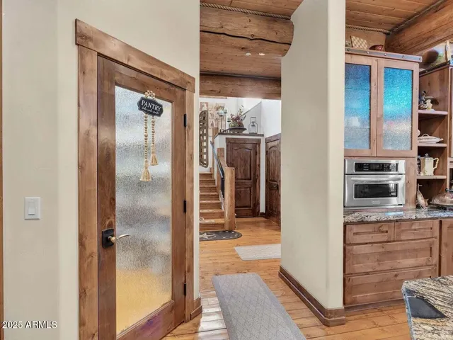 a bedroom with a bed a chandelier and large windows