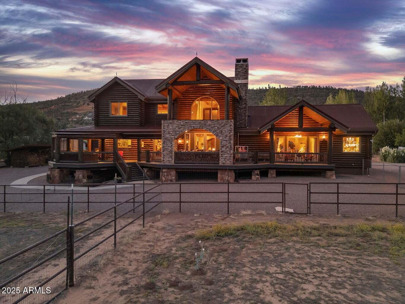 9361 Juniper Road Strawberry, AZ 85544 - Photo 4 of 104 a view of a brick house with wooden fence