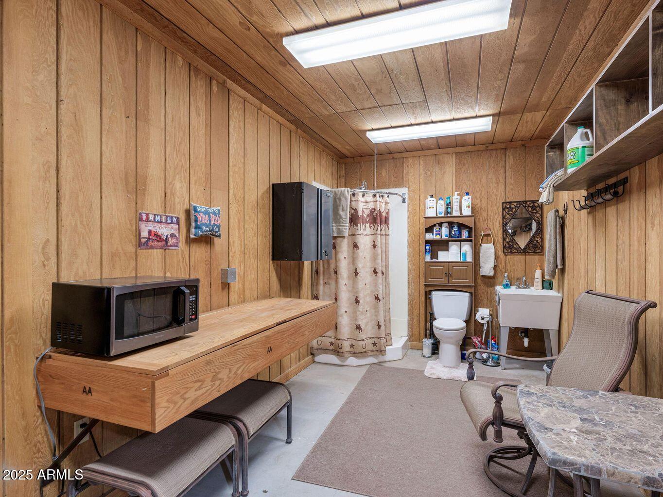 9361 Juniper Road Strawberry, AZ 85544 - Photo 69 of 104 a living room with furniture a flat screen tv and a refrigerator