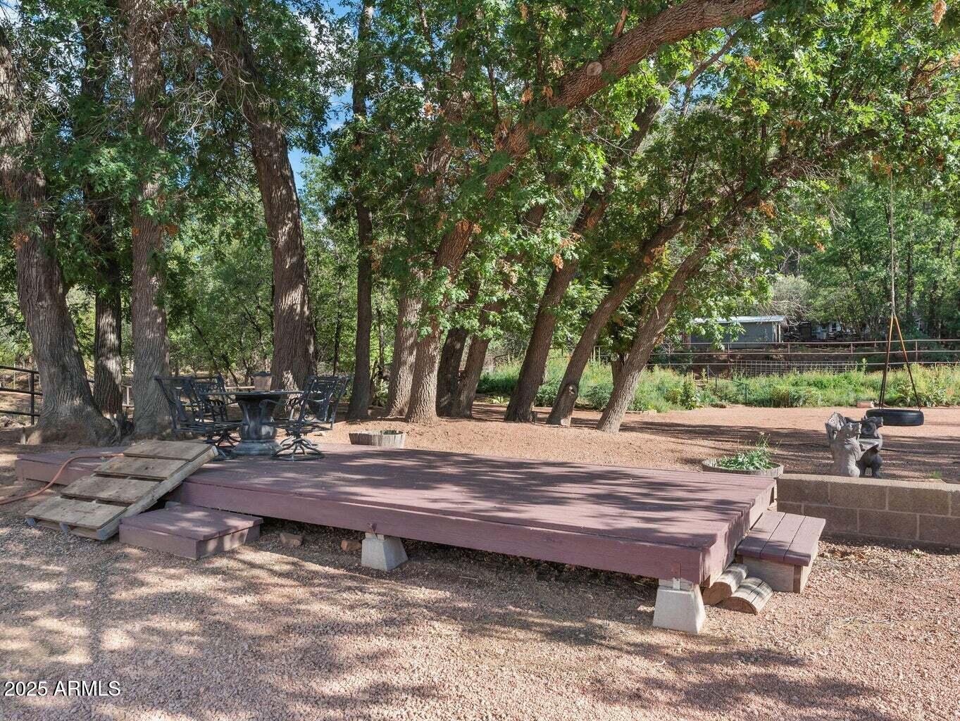 9361 Juniper Road Strawberry, AZ 85544 - Photo 90 of 104 a view of backyard with wooden fence and trees