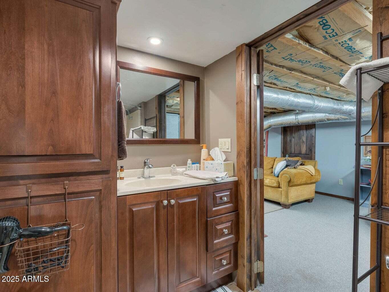 9361 Juniper Road Strawberry, AZ 85544 - Photo 98 of 104 a en suite bathroom with a sink and mirror
