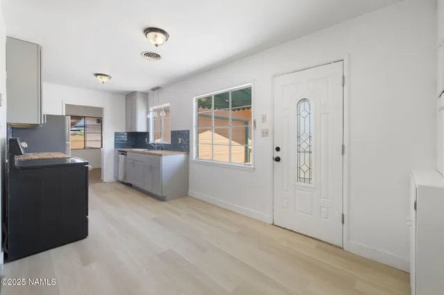a view of a kitchen with granite countertop cabinets and wooden floor