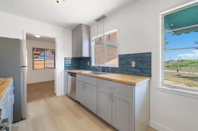 a bathroom with granite countertop a sink and a mirror