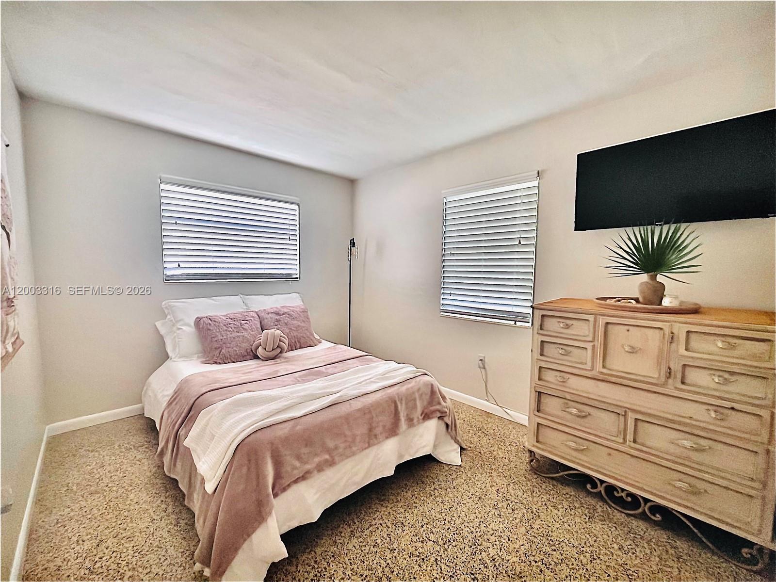 9840 Southwest 165th Terrace Miami, FL 33157 - Photo 12 of 13 a bedroom with a bed and a flat screen tv