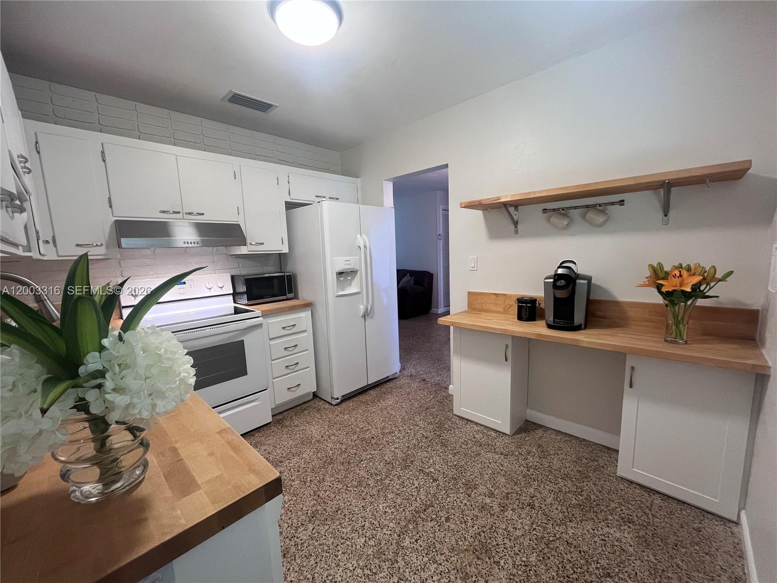 9840 Southwest 165th Terrace Miami, FL 33157 - Photo 2 of 13 a kitchen with appliances a sink and cabinets