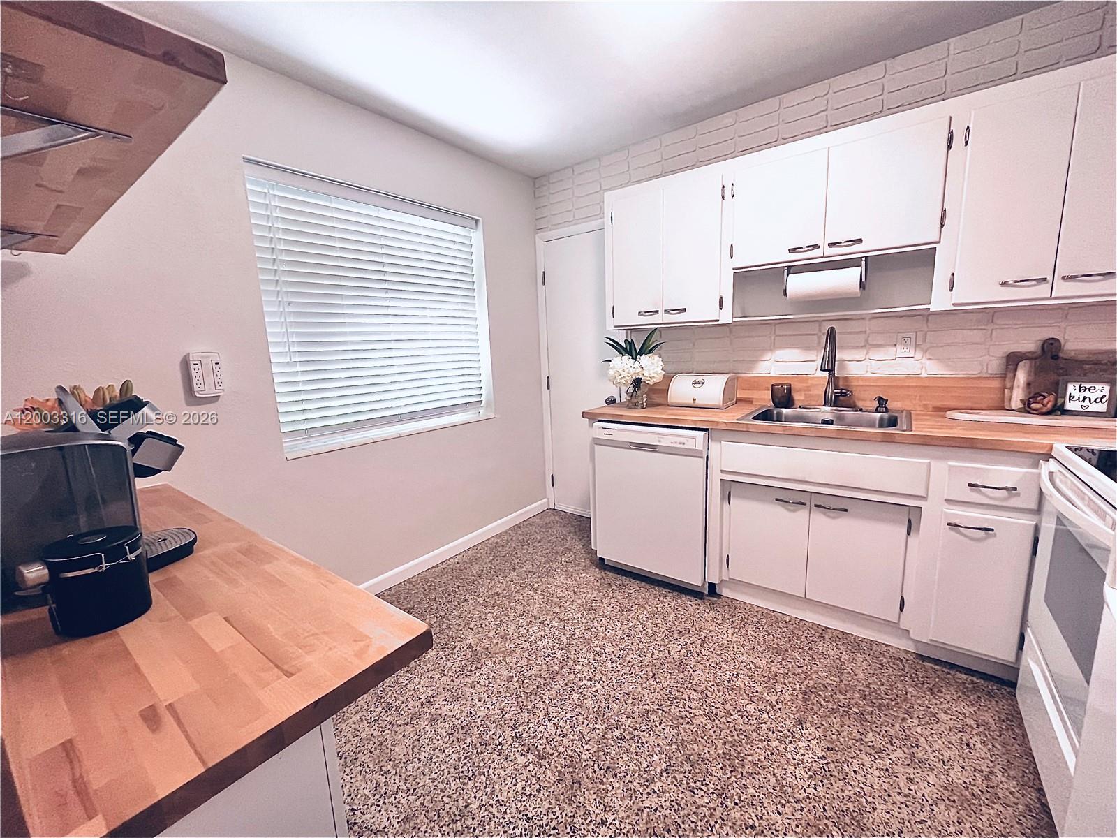 9840 Southwest 165th Terrace Miami, FL 33157 - Photo 3 of 13 a kitchen with a sink stove and cabinets