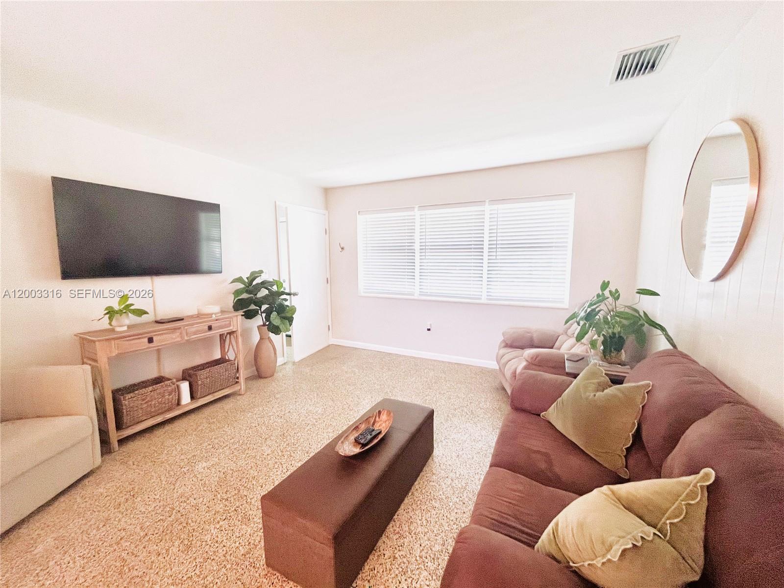 9840 Southwest 165th Terrace Miami, FL 33157 - Photo 8 of 13 a living room with furniture and a flat screen tv