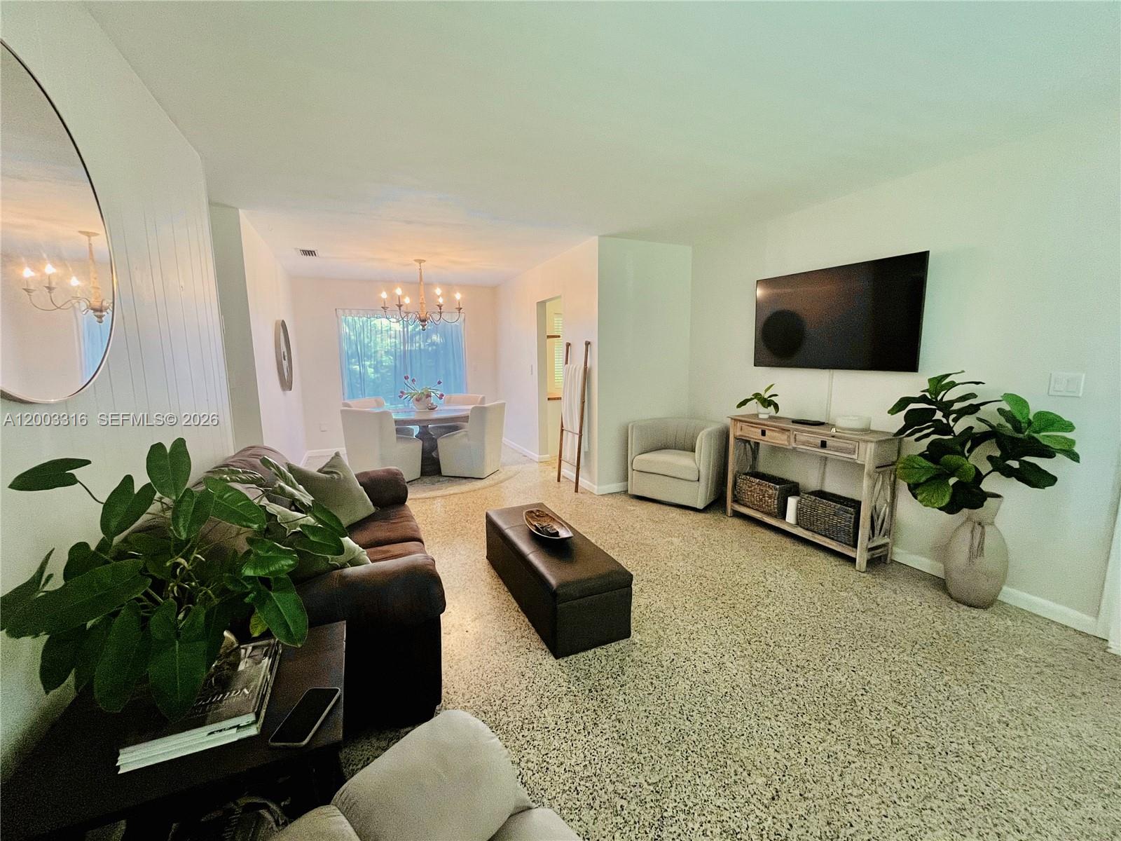 9840 Southwest 165th Terrace Miami, FL 33157 - Photo 9 of 13 a living room with furniture and a flat screen tv