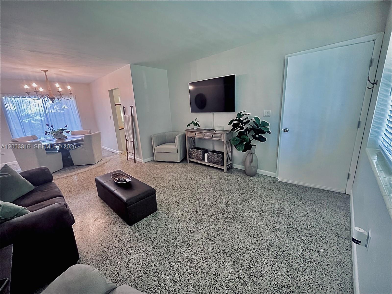 9840 Southwest 165th Terrace Miami, FL 33157 - Photo 10 of 13 a living room with furniture and a flat screen tv