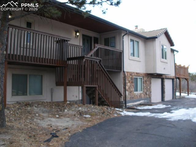 1360 Fawnwood Road Monument, CO 80132 - Photo 2 of 50 a view of a house with wooden floor roof and wooden fence