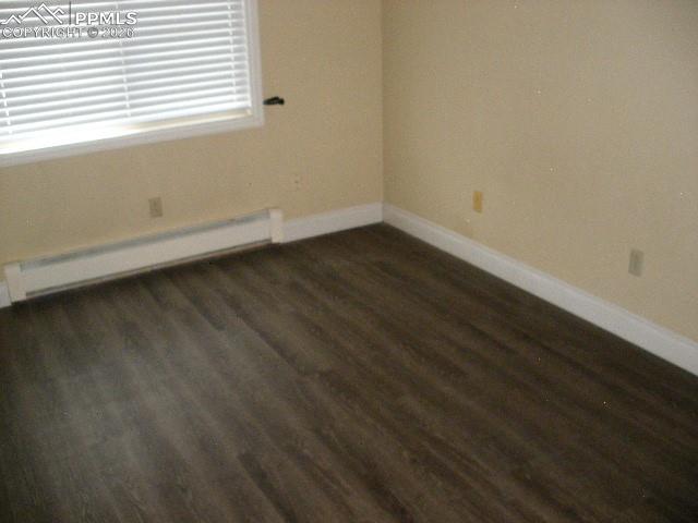 1360 Fawnwood Road Monument, CO 80132 - Photo 30 of 50 a view of a room that has wooden floor and white walls