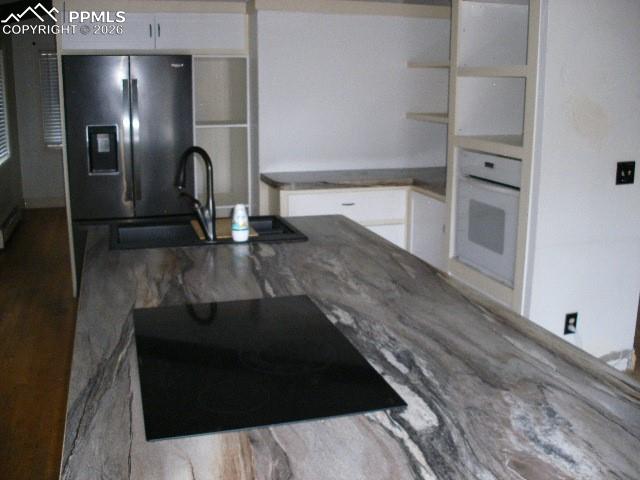 1360 Fawnwood Road Monument, CO 80132 - Photo 10 of 50 a kitchen with a refrigerator and a sink