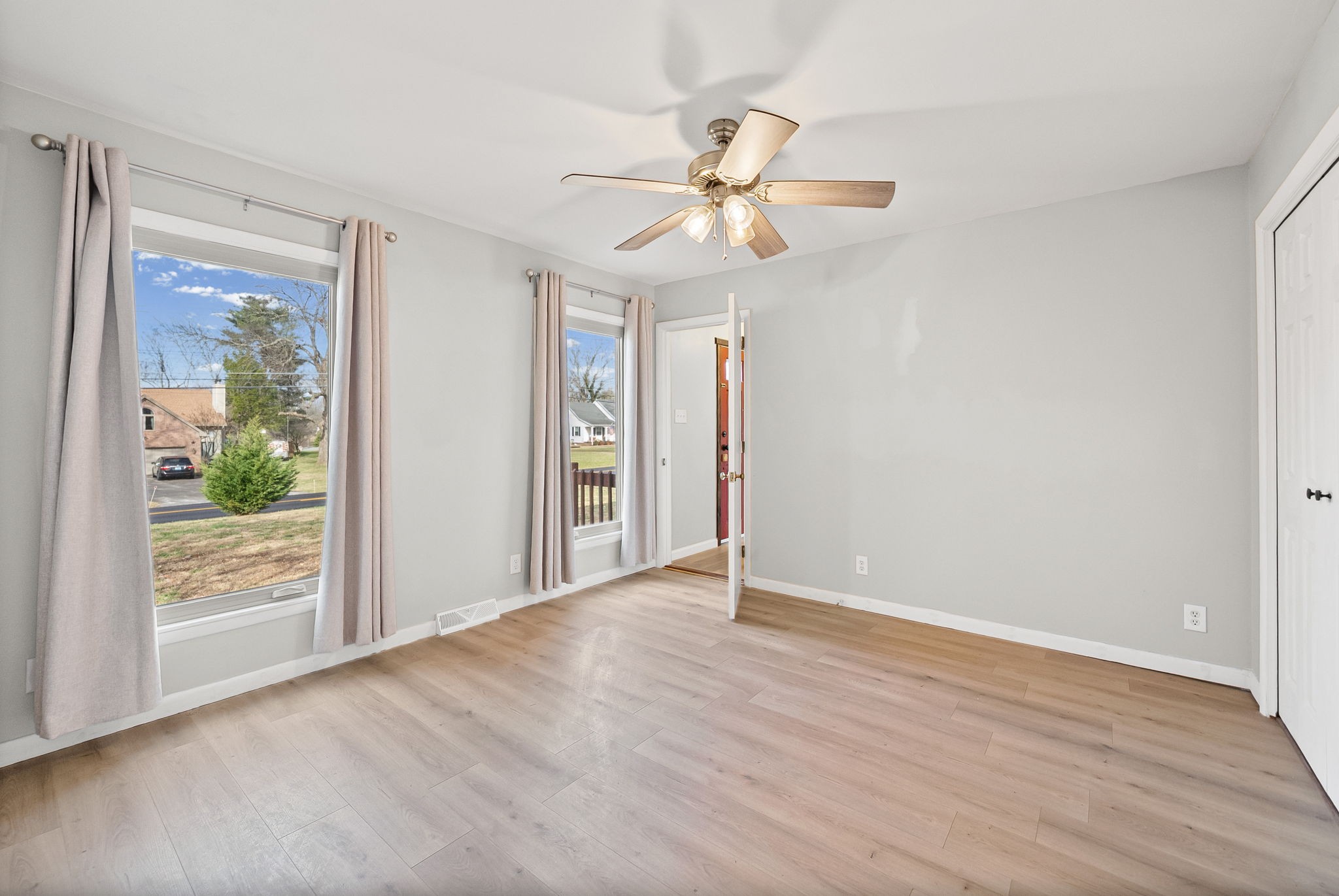 3012 Cox Mill Road Hopkinsville, KY 42240 - Photo 14 of 37 an empty room with wooden floor fan and windows