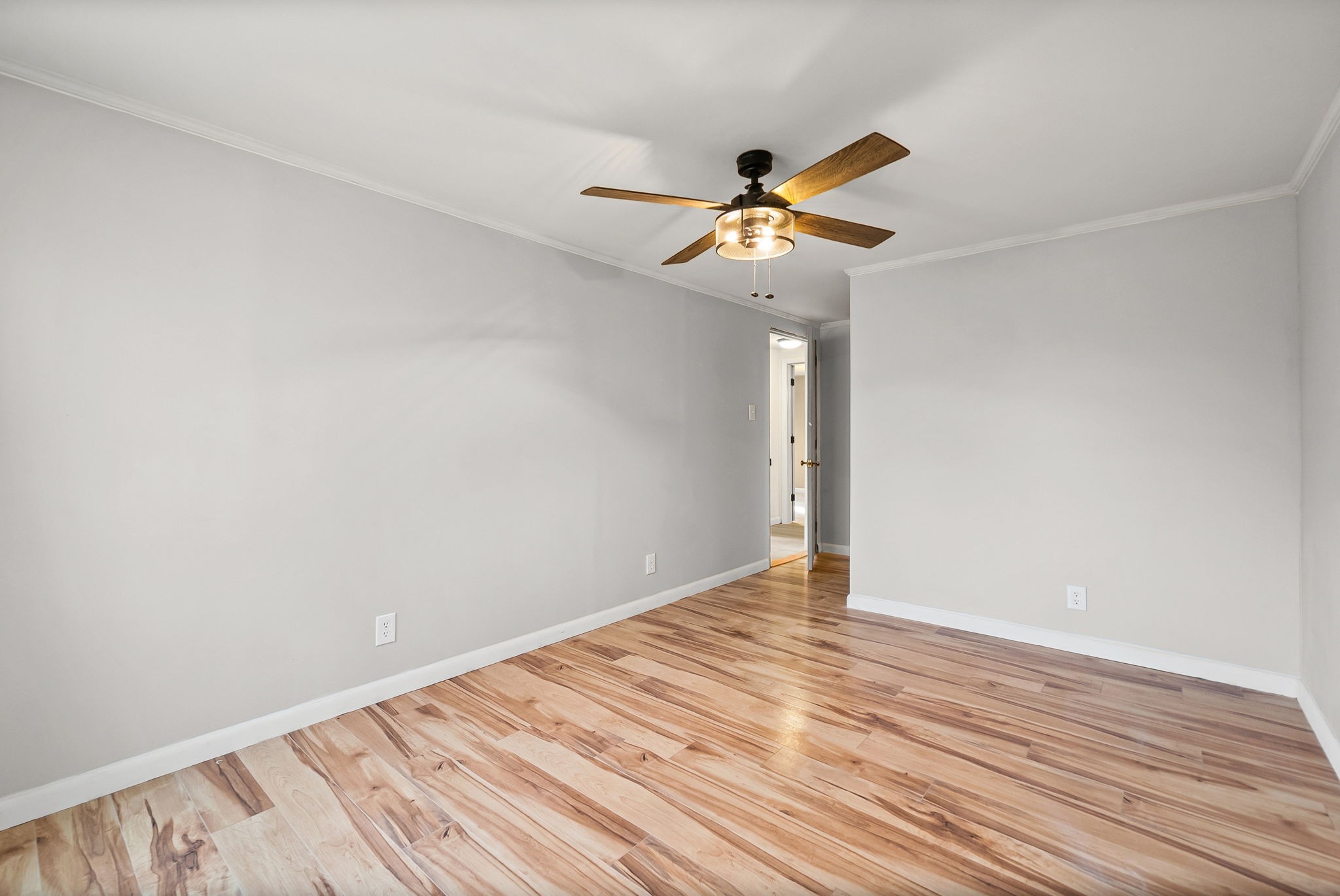 3012 Cox Mill Road Hopkinsville, KY 42240 - Photo 24 of 37 a view of an empty room with wooden floor and a ceiling fan