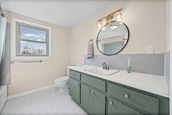 a bathroom with a tub a sink and a shower