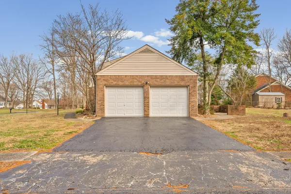 a view of a house with a yard and garage