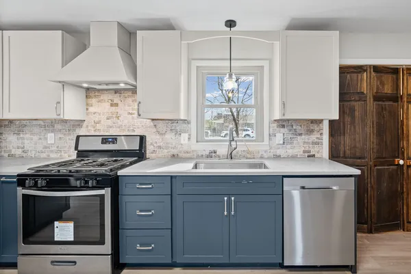 a kitchen with a sink stove and cabinets