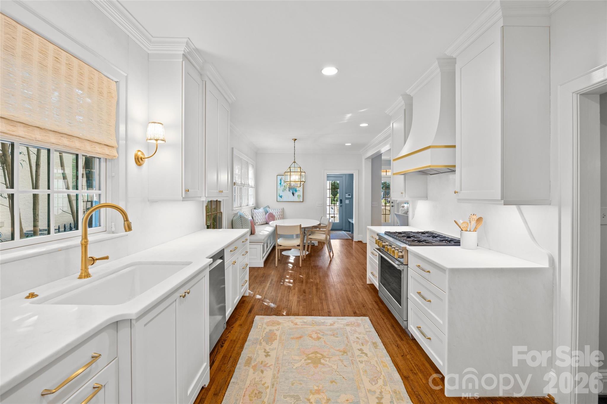 1950 Sterling Road Charlotte, NC 28209 - Photo 15 of 48 a large kitchen with stainless steel appliances lots of counter space and wooden floor