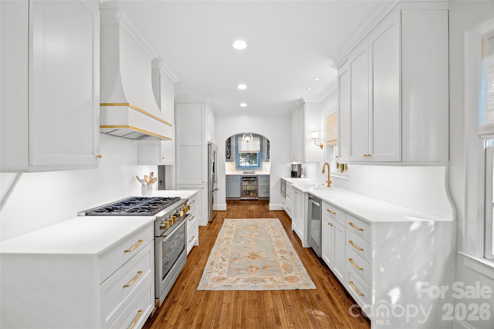 1950 Sterling Road Charlotte, NC 28209 - Photo 20 of 48 a large kitchen with stainless steel appliances granite countertop a lot of counter space and wooden floors