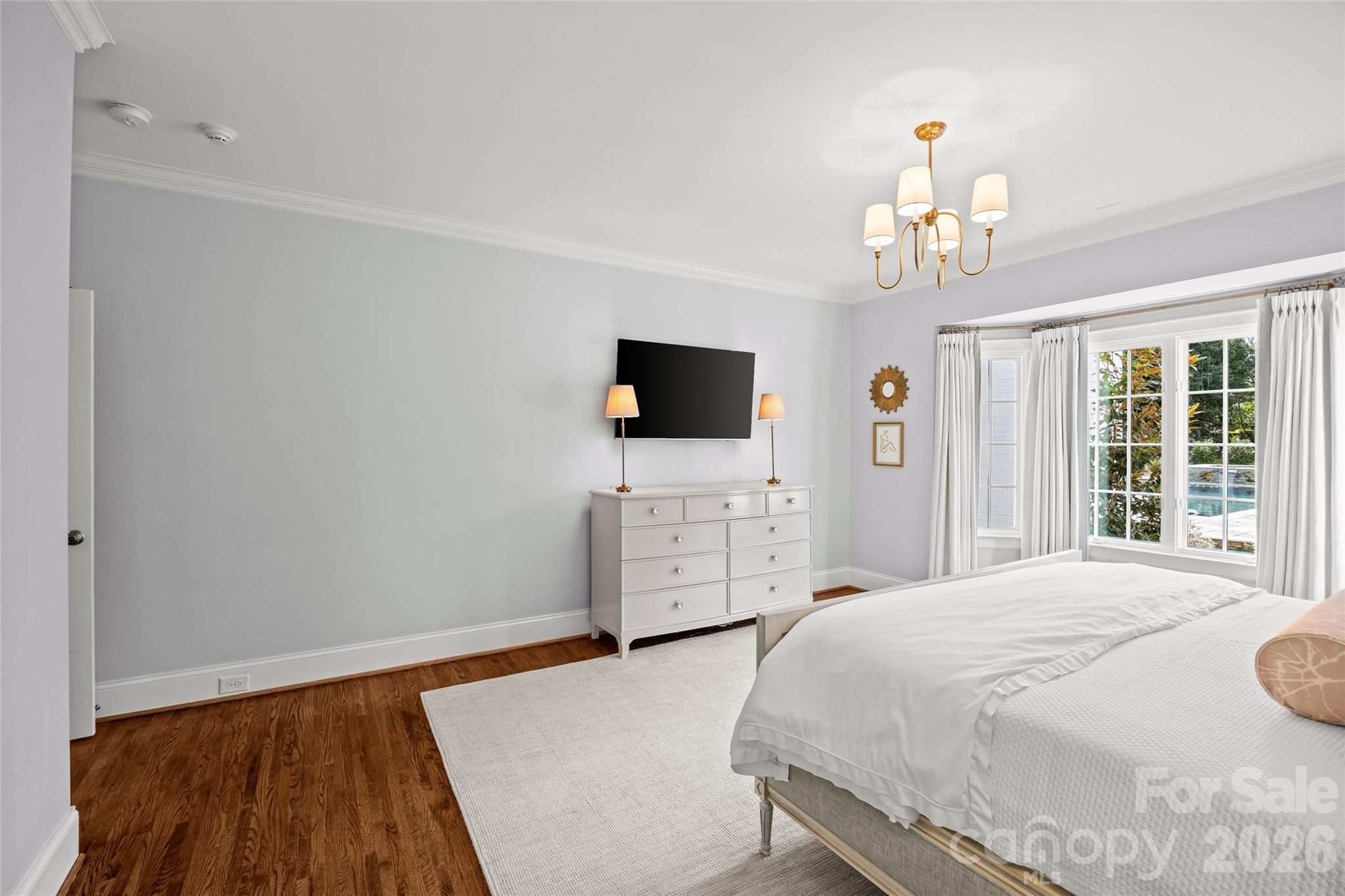 1950 Sterling Road Charlotte, NC 28209 - Photo 25 of 48 a spacious bedroom with a bed and a flat screen tv