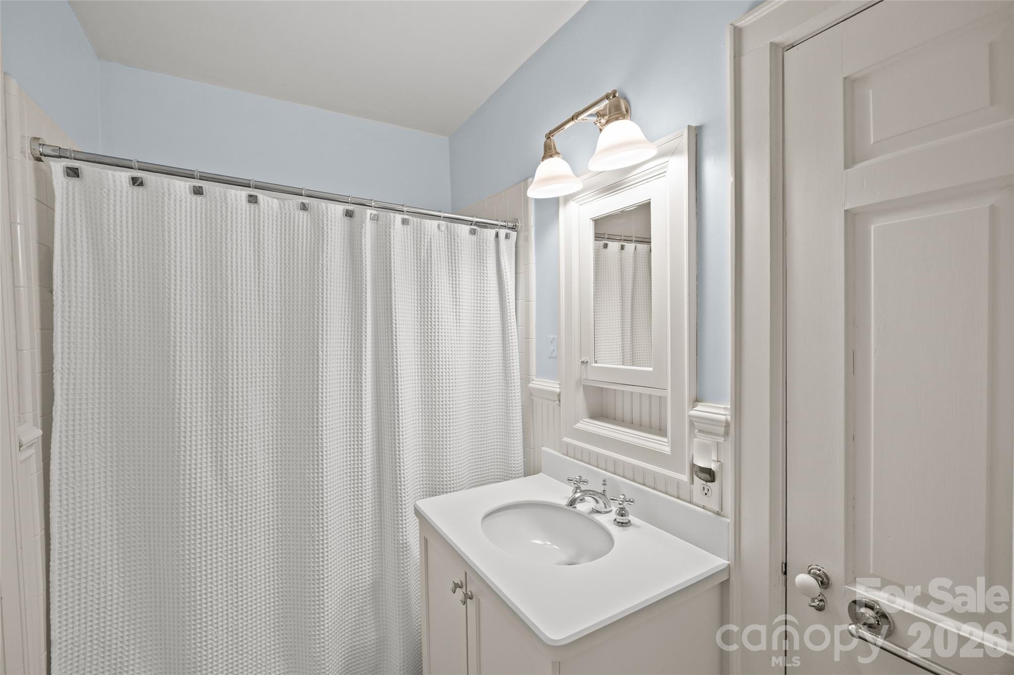 1950 Sterling Road Charlotte, NC 28209 - Photo 35 of 48 a bathroom with a sink and a mirror