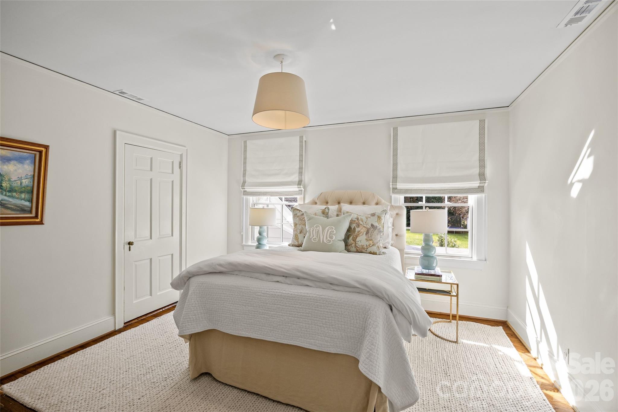 1950 Sterling Road Charlotte, NC 28209 - Photo 36 of 48 a bedroom with a bed lamp and a window
