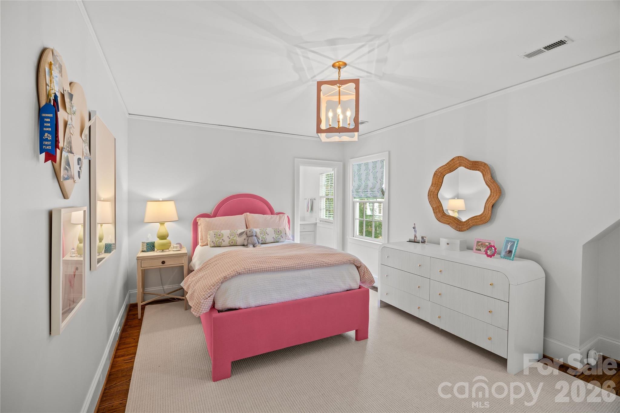 1950 Sterling Road Charlotte, NC 28209 - Photo 37 of 48 a bedroom with a bed and a chandelier