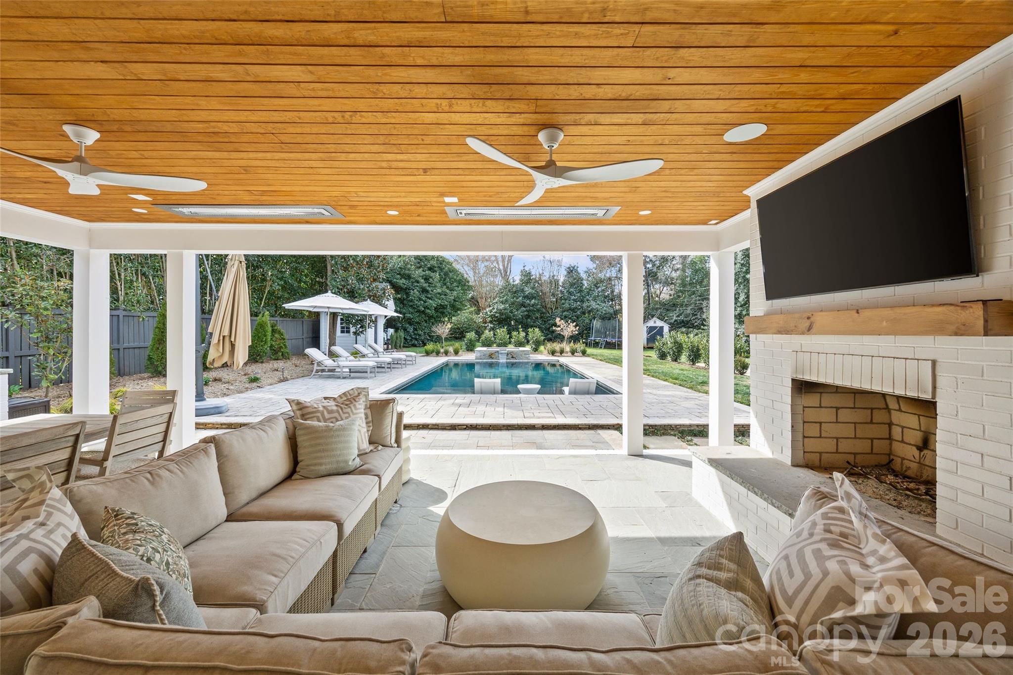 1950 Sterling Road Charlotte, NC 28209 - Photo 43 of 48 a living room with furniture a fireplace and a flat screen tv