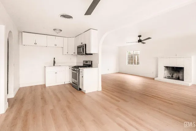 a view of kitchen with sink and wooden floor