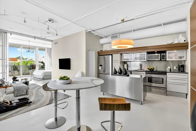 a kitchen with stainless steel appliances kitchen island granite countertop a sink and cabinets