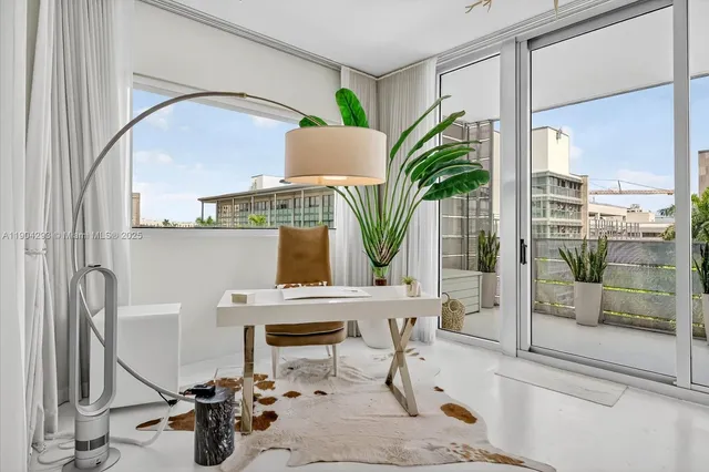 a view of a living room with furniture and a window