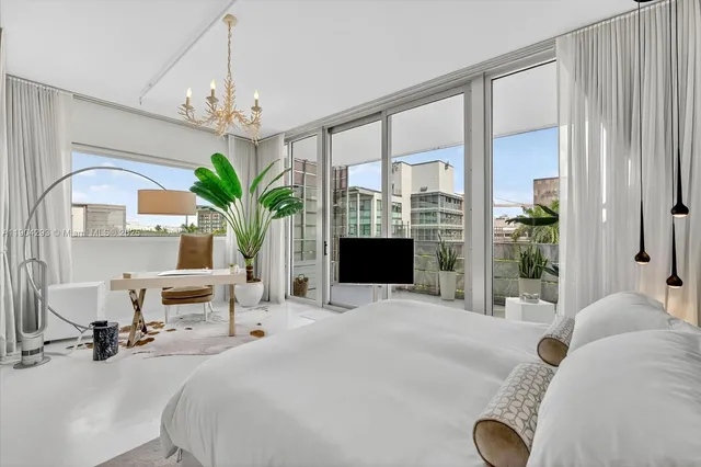 a bedroom with a bed and a chandelier