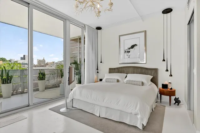 a spacious bedroom with a bed and a large window