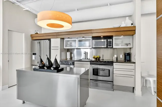 a kitchen with stainless steel appliances granite countertop a stove and a sink