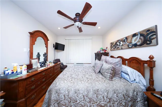 a bedroom with a bed and ceiling fan