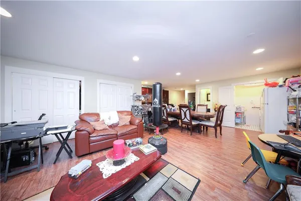 a living room with furniture a wooden floor and next to a window