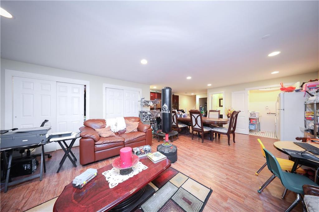 8785 14th Avenue, Unit 1B Brooklyn, NY 11228 - Photo 15 of 29 a living room with furniture a wooden floor and next to a window