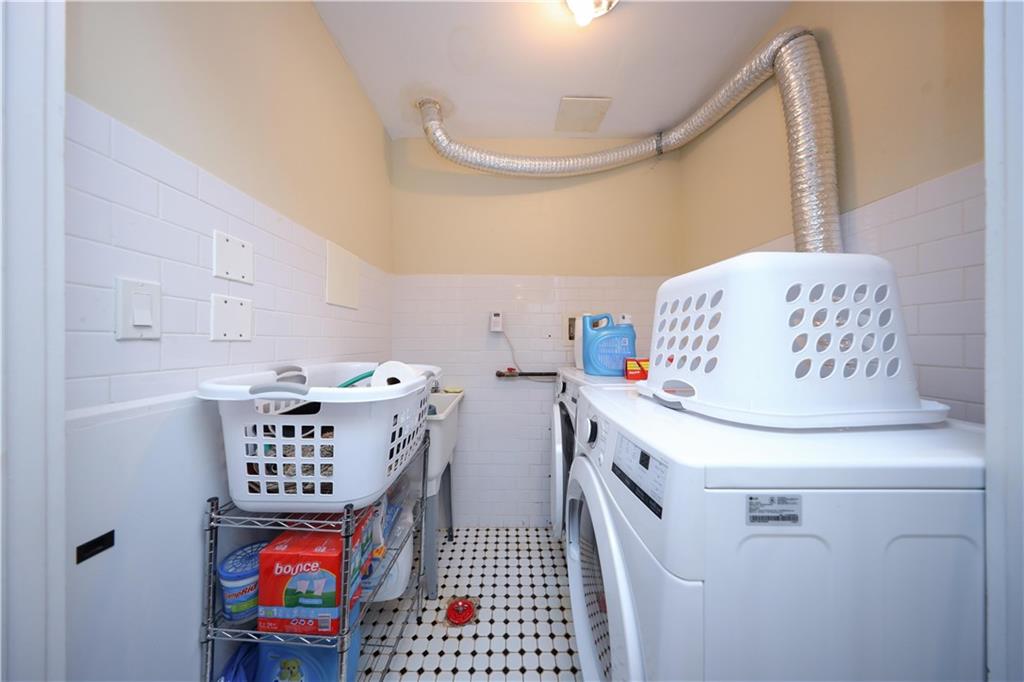 8785 14th Avenue, Unit 1B Brooklyn, NY 11228 - Photo 17 of 29 a utility room with fridge and wooden floor