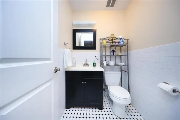 a bathroom with a toilet a sink and mirror