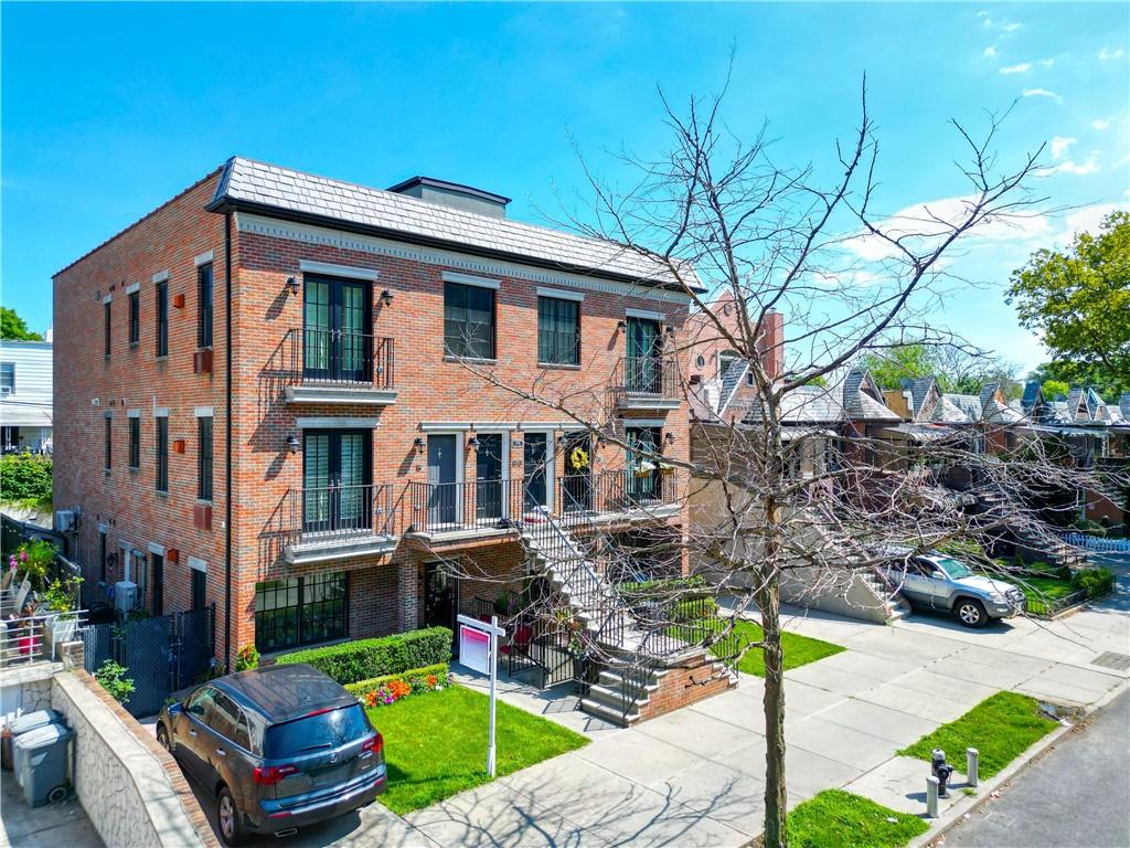 8785 14th Avenue, Unit 1B Brooklyn, NY 11228 - Photo 23 of 29 a front view of a house with garden