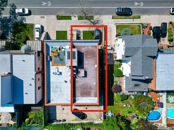an aerial view of a house with a garden and lake view