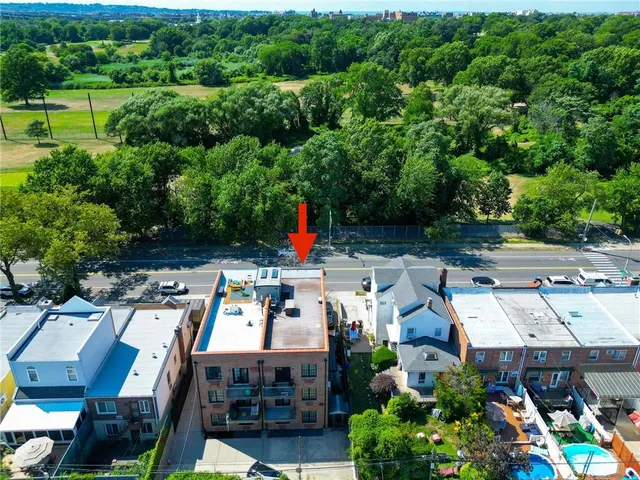 an aerial view of a house with a garden and lake view