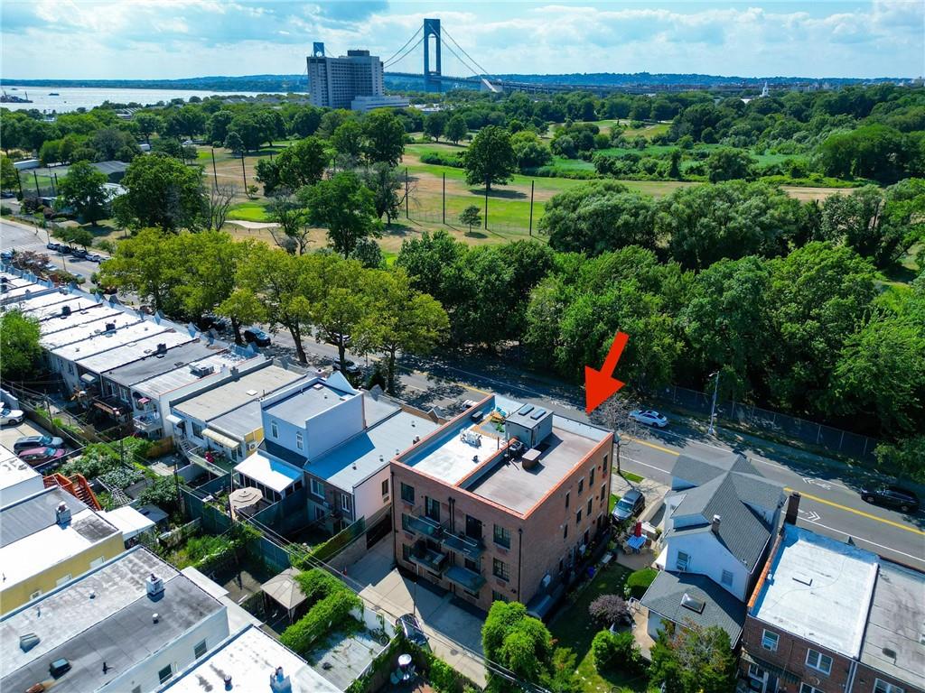 8785 14th Avenue, Unit 1B Brooklyn, NY 11228 - Photo 27 of 29 an aerial view of a house with a garden and lake view
