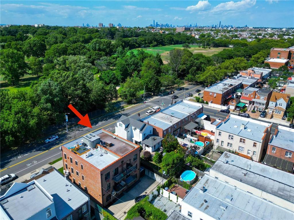 8785 14th Avenue, Unit 1B Brooklyn, NY 11228 - Photo 28 of 29 an aerial view of a house with a garden and lake view