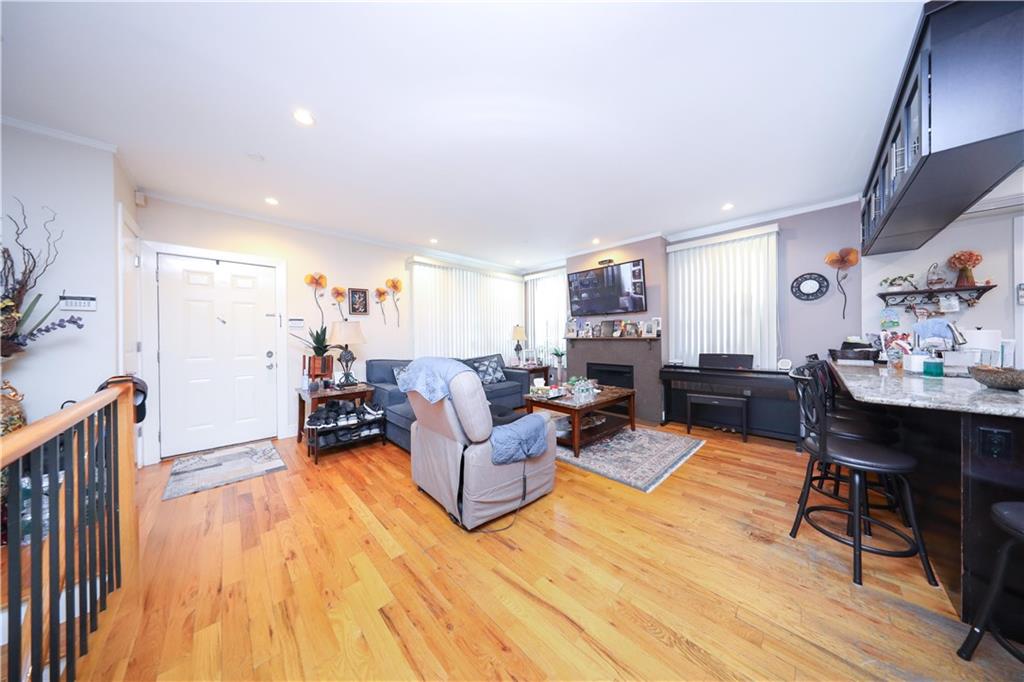 8785 14th Avenue, Unit 1B Brooklyn, NY 11228 - Photo 4 of 29 a living room with furniture and a wooden floor