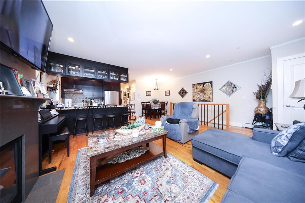 8785 14th Avenue, Unit 1B Brooklyn, NY 11228 - Photo 6 of 29 a living room with furniture and a rug