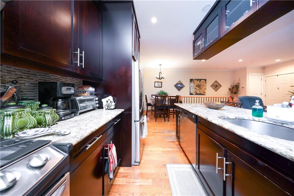 8785 14th Avenue, Unit 1B Brooklyn, NY 11228 - Photo 9 of 29 a kitchen with stainless steel appliances granite countertop counter space a sink and cabinets
