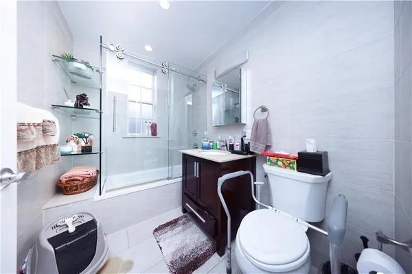 a white toilet sitting next to a bathroom sink and vanity