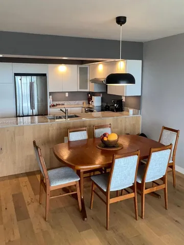 a dining room with a table and chairs