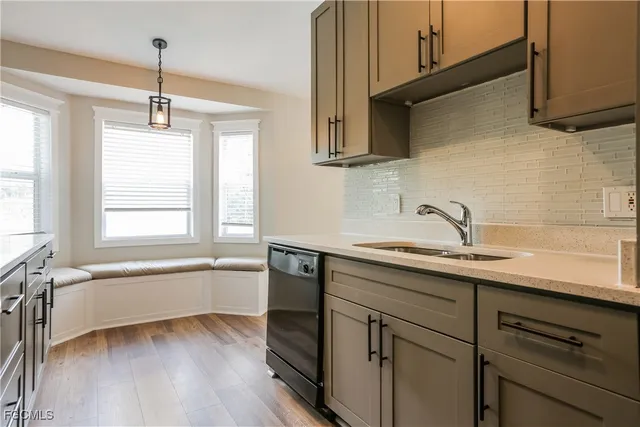 a kitchen with a sink cabinets and window